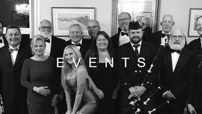Ross McNaughton of Tay Piping at a formal event with guests